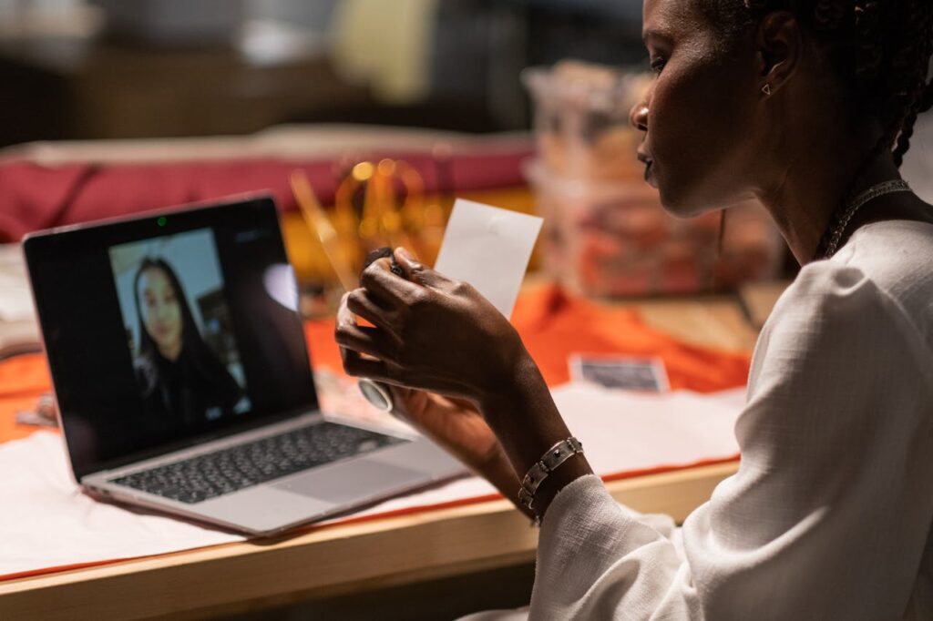 Creative professional working remotely, conducting a virtual meeting with laptop indoors.
